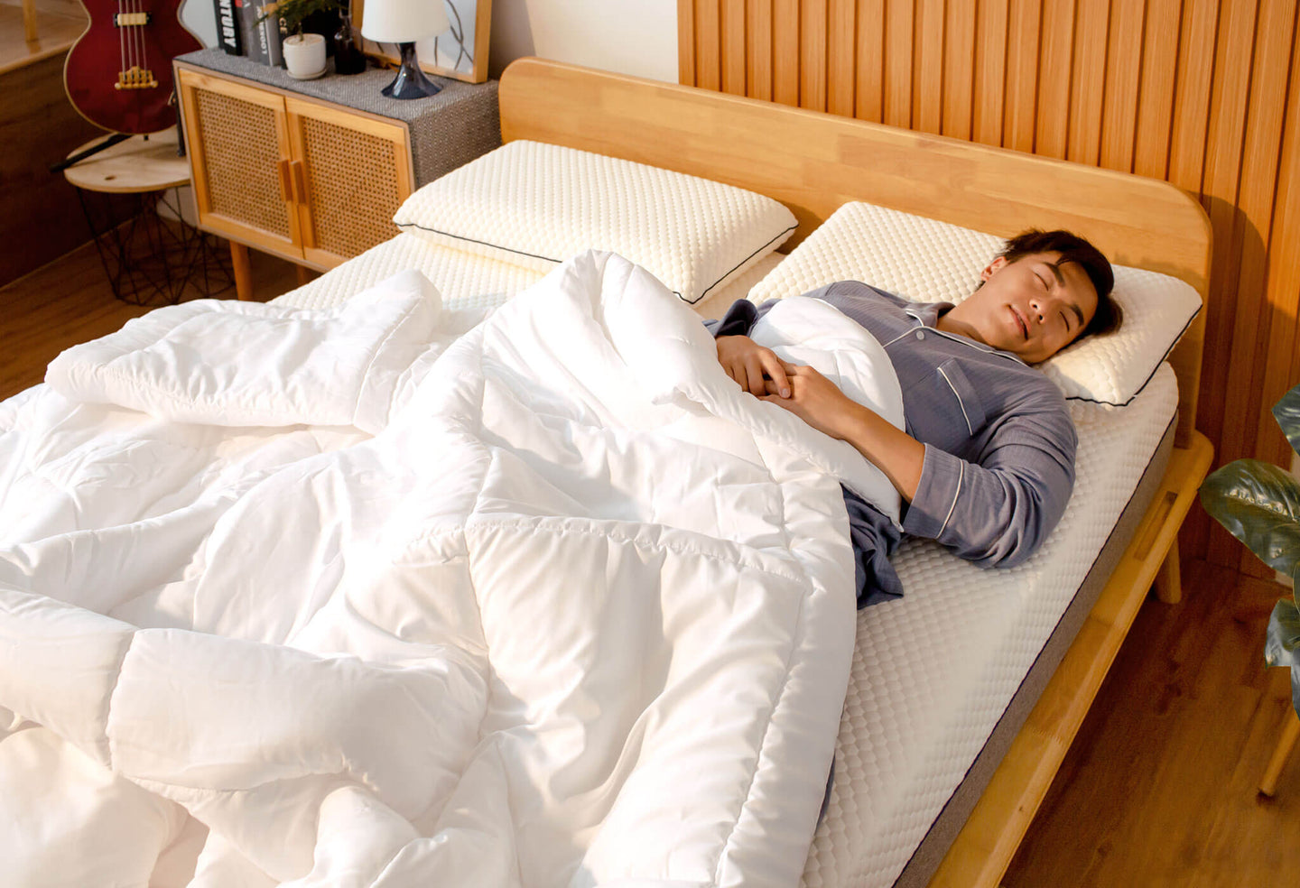 Man sleeping under Sonno Duvet in a Japandi bedroom